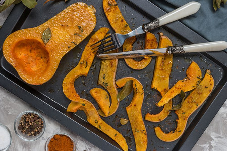 在烤盘上用盐甜辣椒和百合香肠煮熟的烤切碎胡桃花瓜图片