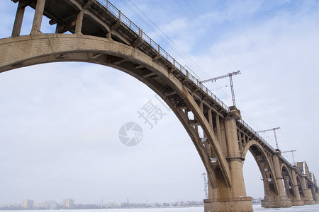 冰冻河流上方的铁路大桥宽角图片