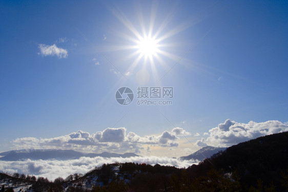 寒冬阳光照耀着雪山图片