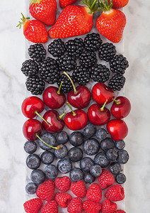 白大理石板上的新鲜有机夏季果酱轻厨房桌底背景草莓蓝黑和樱桃背景图片