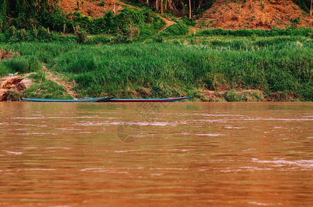 黄水中的亚裔当地渔民船和绿海岸线的马康河农村景点图片