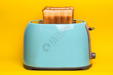 黄色背景的青烤面包机图片
