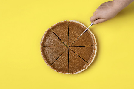 女手切成一片黄底南瓜馅饼最美味的传统感恩甜点图片