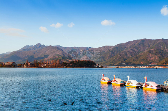 冬天美丽的湖川口子与天鹅水轮船和山景图片