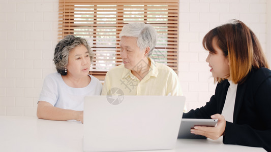通过文件平板电脑和笔记本为老年夫妇提供医疗保险图片