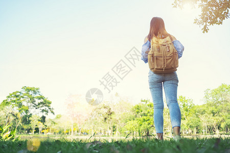 年轻女旅行者站在户外阳光照耀冒险旅行和自由概念图片