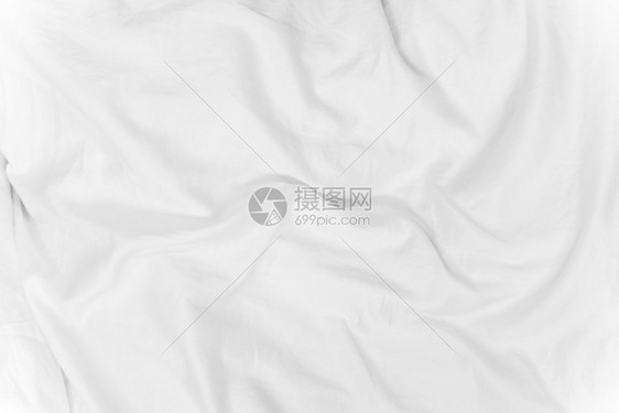 清晨时日光照在床上的白花织布纹理抽象背景图片