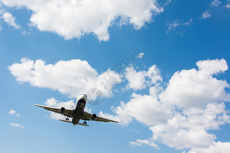 飞机在美丽的蓝天白云中飞行图片