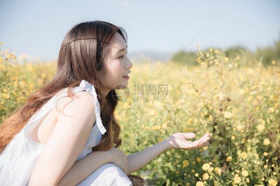 坐在花园里微笑着的年轻亚洲女孩肖像图片