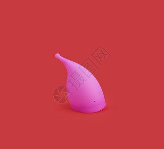 红背景的粉色可重复使用的硅酮月经杯图片