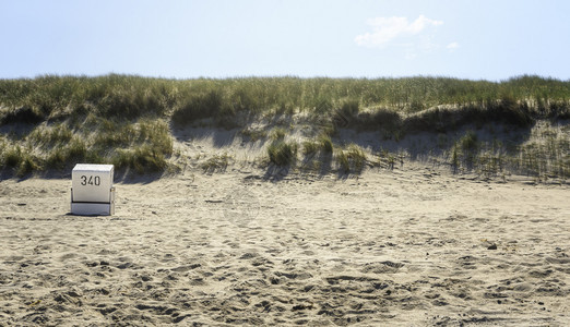 锡尔特岛的海滩景观有草沙丘和单张椅最起码的海滩景色图片