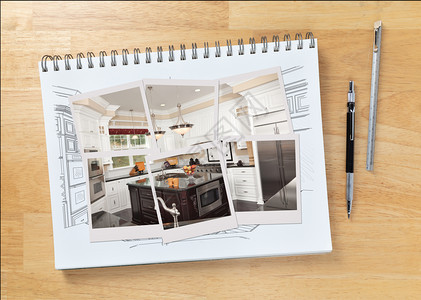 桌边的草图垫上画着自订厨房的内部和照片框显示工程铅笔和标尺旁边的建筑已完成图片