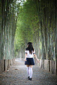 穿着制服的高中生在竹林里拍照图片