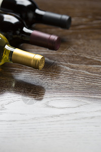 反射木质表面抽象物上的各种葡萄酒瓶图片