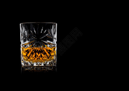 晶优雅玻璃杯中威士忌黑色背景反射文本空间图片