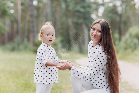 美丽的母亲与女婴在森林中玩得很开心公园暑假的概念母亲和婴儿白天一起度过时间家庭阳光照选择关注美丽的母亲与女婴一起在森林中玩得很开图片