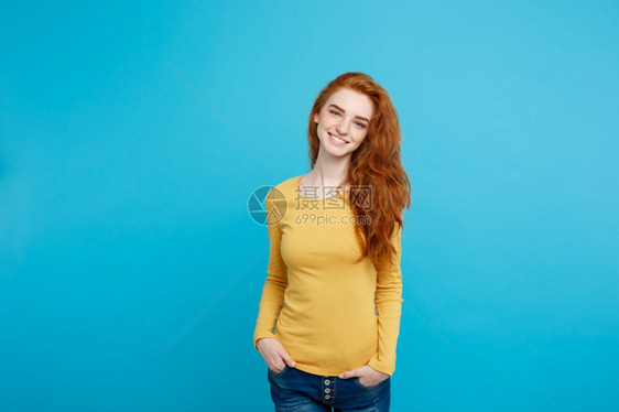 年轻美丽的姜女士肖像雀斑欢笑的容看着镜头孤立在面部蓝色背景上复制空间图片