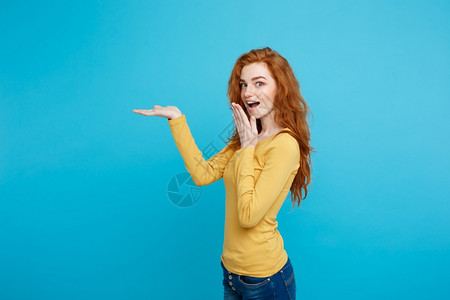 快乐的姜红发女孩头像手指向外令人震惊的表情面部蓝色背景复制空间乐趣和人的概念手向外复制空间图片