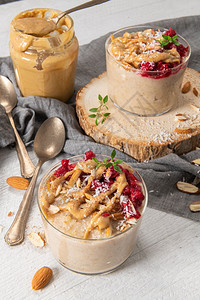 早餐燕麦粥配有草莓杏仁肉桂黄油和椰子健康早餐美味的自制英语早餐概念图片