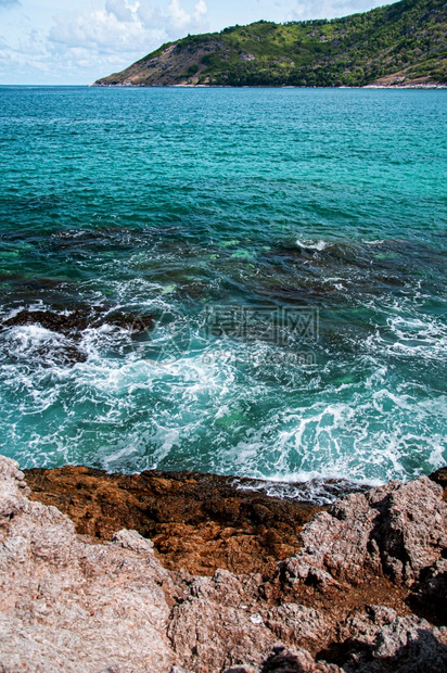 绿宝石蓝色海浪和边的岩石岸位于普吉的亚努伊海滩图片