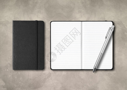 黑闭和开线笔记本有钢混凝土背景上隔离的模型黑闭和开线笔记本有混凝土背景上的笔图片