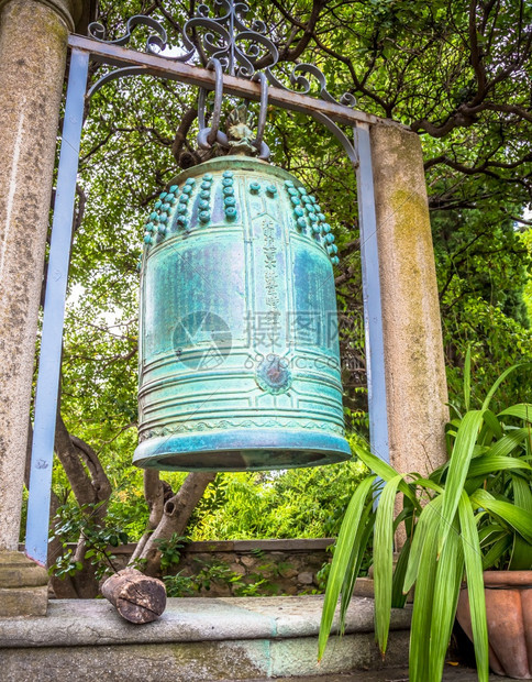 位于汉伯里花园的古老日本钟声并精细地用铜制成它似乎来自日本中部被火烧毁的佛教圣地图片