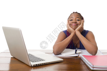 非洲女在办公桌上用笔记本电脑工作与白种背景隔绝图片