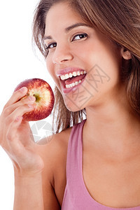 一个带着苹果微笑的健康女孩肖像图片