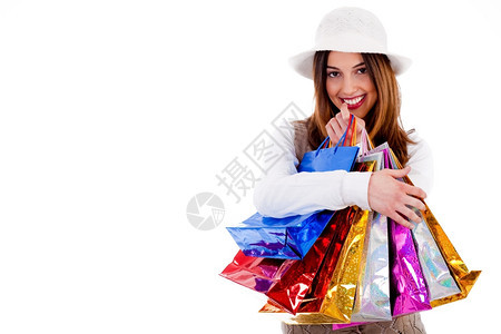 年轻女士的肖像在一个孤立的背景下对许多购物袋感到快乐图片