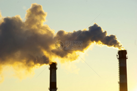 日落下烟雾的发电厂图片