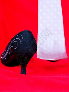 黑女鞋和红色背景的领带图片
