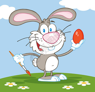 快乐的灰色兔子绘制复活节鸡蛋图片