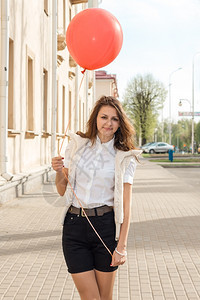 红气球的美时装女郎在老城的空街上图片