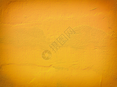 黄色橙油漆混凝土壁背景或纹理背景图片