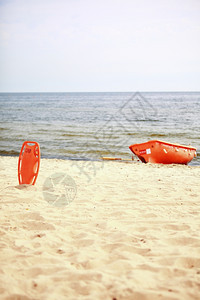 拯救海滩生命员设备橙保护工具和船沙滩红塑料浮力援助图片