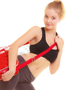 运动和积极生活方式运动的健身女孩穿着运动服红色运动包图片