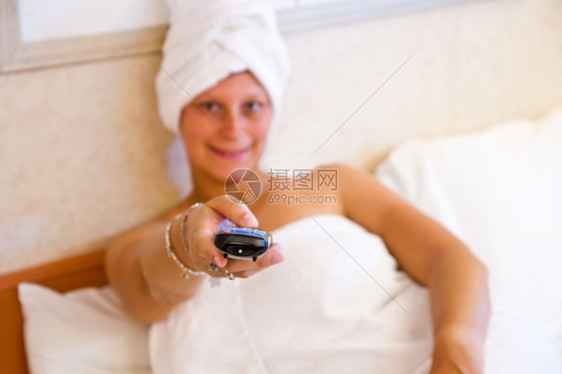 妇女在床上看电视图片