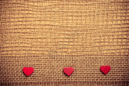 红色木质装饰心脏带在抽象布上带复制空间的薄布背景上图片
