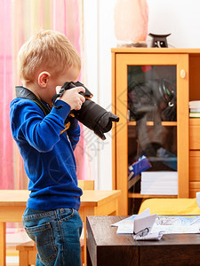 快乐男孩子玩相机在家拍照图片