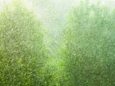 在窗外的夏季雨中水滴在玻璃窗上作为背景纹理图片