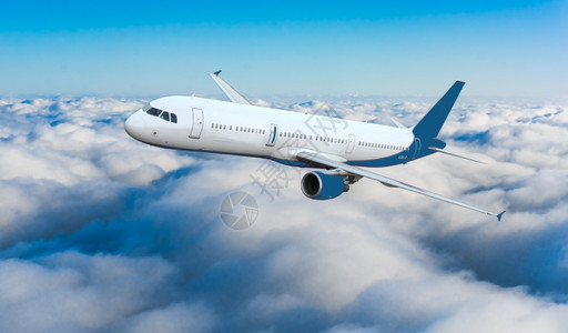 蓝色空中客机飞行蓝色的客机在云层中飞行背景图片