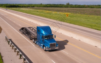 一辆空的蓝色运货拖车沿高速公路行驶图片