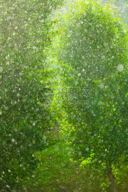 在窗外的夏季雨中水滴在玻璃窗上作为背景纹理图片