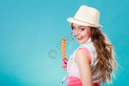 戴着帽子的女模特在吃冰棒背景图片