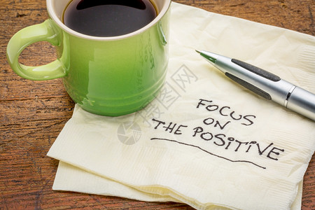 关注积极的激励字词手写在餐巾纸上加一杯咖啡图片