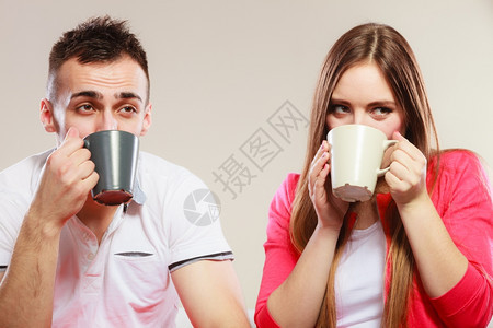 有吸引力的情侣一起喝茶或咖啡男女一起拿着杯子和热饮图片