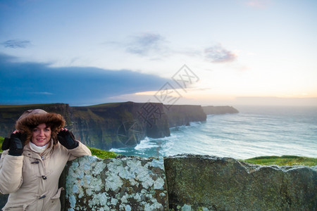日落时在莫赫尔悬崖上观光的女游客位于CoClare爱尔兰欧洲美丽的景观自然色吸引人图片