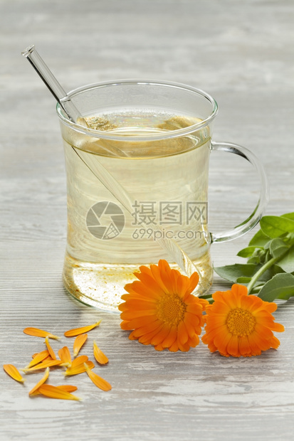 玻璃杯加茶壶马龙鲜花和叶子图片