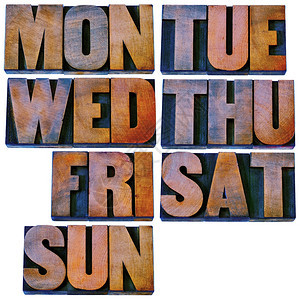 每周7天头3个字母符号在用彩色墨水染的孤立旧式纸质印刷木材机板上图片