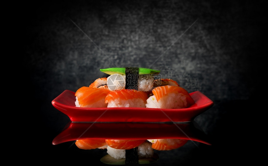 红盘和黑色底的寿司图片